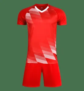 Detail of red soccer uniform set with white V-neck jersey and matching athletic shorts.