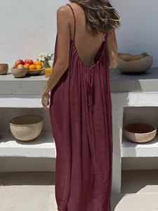 Back view of wine red backless maxi dress with delicate spaghetti straps and ruching.