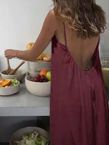 Detailed view of the elegant burgundy backless slip dress with wrinkled ice silk texture