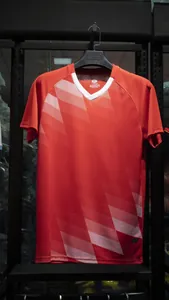 Detailed view of the red soccer jersey with white geometric gradient patterns on the front