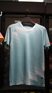 Detail of light blue V-neck football jersey with white geometric pattern on hanger