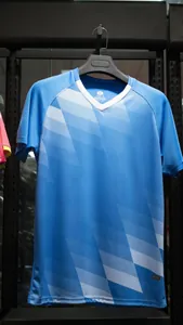 Detail shot of a blue soccer training jersey featuring white geometric patterns and V-neck design