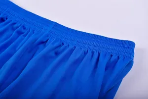 Close-up detail of the elastic waistband on professional blue soccer training shorts.