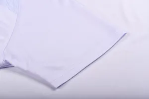 Macro detail of the breathable mesh fabric and double-stitched sleeve of a jersey