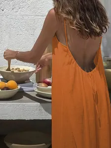 Detail view of an orange ice silk crinkle backless slip maxi dress for beach holidays.