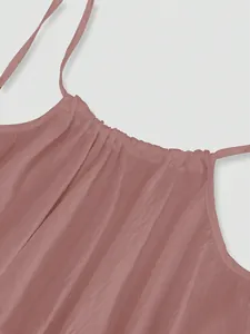 Close-up view of the gathered pleated neckline and straps on a mauve ice silk beach dress