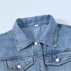 Vintage blue denim jacket for women featuring white button details and chest pockets.