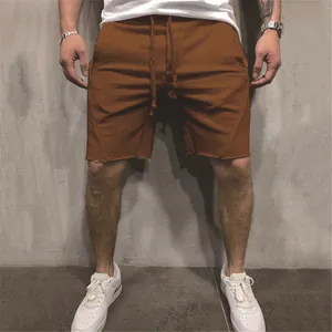 Detailed view of men's brown raw hem casual sports shorts with drawstring waist
