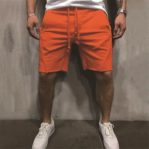 Vibrant orange men's athletic running shorts with raw hem and drawstring closure
