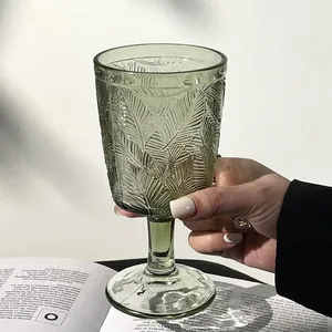 Verre à pied rétro français vert avec motif feuille en relief et ambiance lifestyle