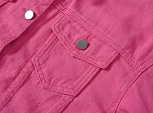 Primer plano detallado de una chaqueta vaquera rosa con bolsillo y botones de metal