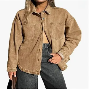 Detailed view of women's oversized khaki denim shirt jacket with large front pockets
