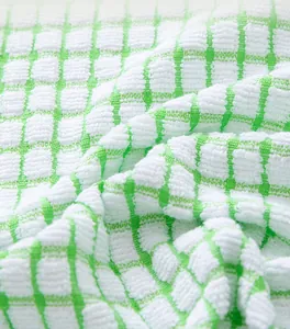 Macro view of soft green and white checkered cotton tea towel with knit texture
