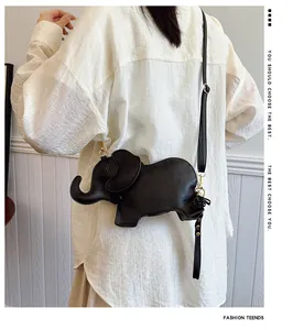 Detail of cute black elephant-shaped PU leather crossbody bag worn by a model