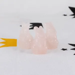 Close-up of three carved pink rose quartz rabbit figurines as cute Easter ornaments