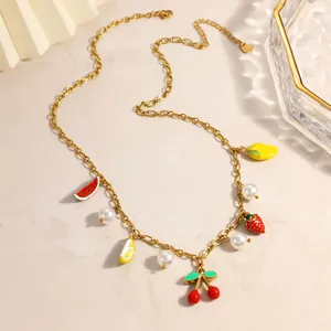 Detail of 18K gold plated stainless steel necklace with fruit charms and pearls.