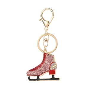 Detailed macro view of the ice skate keychain with pink rhinestones and red enamel.