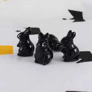 Detailed view of hand-carved natural black obsidian rabbit figurines for Easter decor