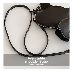 Detail view showing the adjustable shoulder strap on this cute black elephant PU leather bag