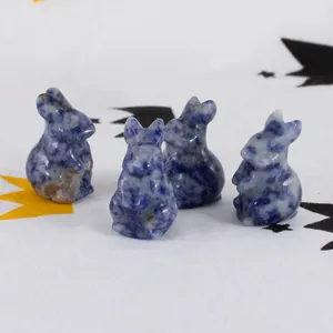 Detail of hand-carved natural blue sodalite crystal rabbit figurines for Easter decor.