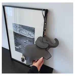 Detail of a grey elephant shaped PU leather wristlet pouch for women with tassel