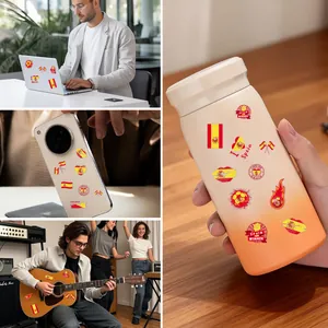 Spain flag temporary tattoos shown on laptop, phone, and guitar for soccer fans.