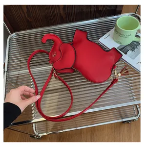 Detailed view of a cute red elephant shaped PU leather crossbody bag with tassel