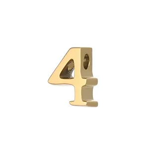 Macro view of a polished gold-plated stainless steel number 4 charm for DIY jewelry