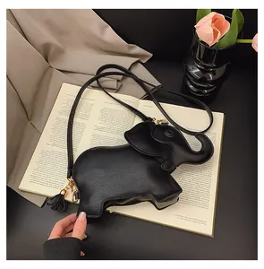 Cute black elephant-shaped PU leather crossbody bag featuring a flower tassel charm