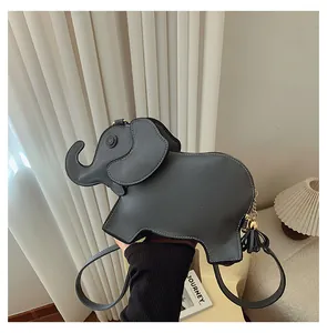 Detailed side view of dark grey elephant shaped PU leather crossbody bag with tassel