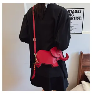 Back view of cute red elephant-shaped crossbody bag worn over a black blazer.