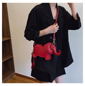 Red PU leather elephant shaped crossbody bag shown being worn with a black blazer.