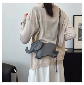 Cute gray elephant-shaped PU leather crossbody bag worn as a stylish fashion accessory