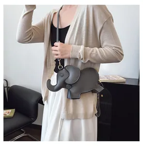 Detail of a cute grey elephant-shaped PU leather crossbody bag worn by a model