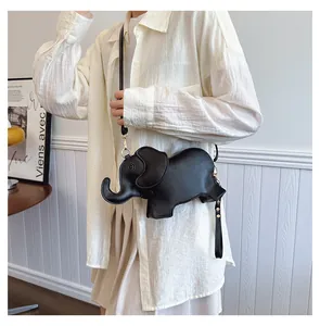 Detail view of a cute black elephant-shaped PU leather crossbody bag worn by a model