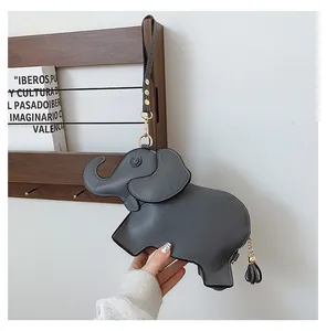 Detailed close-up of a cute elephant-shaped gray PU leather purse with wrist strap