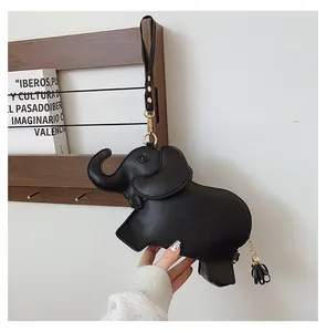 Close-up view of a cute black elephant shaped PU leather handbag with gold tassel detail