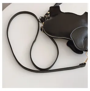 Detail view of black PU leather elephant shaped crossbody bag with gold zipper.