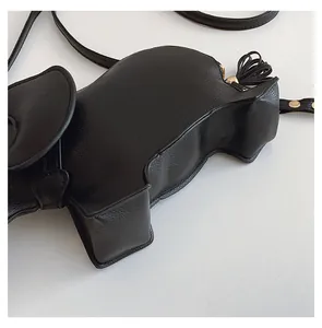 Close-up detail of a cute black elephant-shaped PU leather crossbody bag with grain