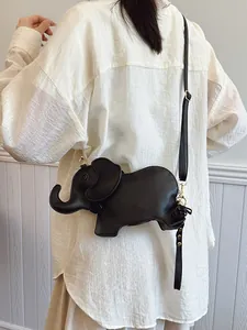 Minimalist black elephant-shaped PU leather crossbody bag shown on a female model