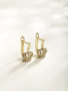 Detail view of luxury gold crown hoop earrings with sparkling pavé cubic zirconia.