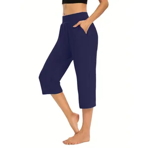 Side view of navy blue women's capri joggers with pockets and elastic waist