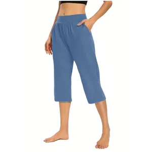 Detail view of women's blue solid color loose elastic athletic capri pants with pockets.