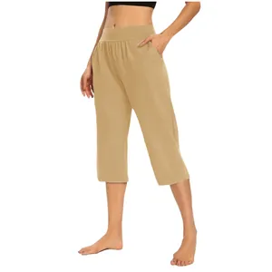Detail view of khaki elastic high waist cropped pants with side pockets.
