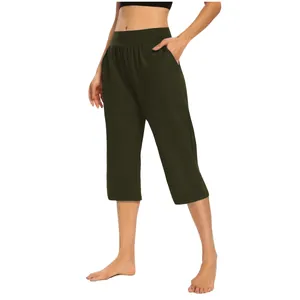 Close-up of women's olive green yoga capri pants with pockets and stretchy waistband