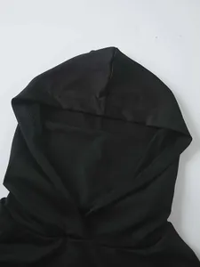 Detail of the integrated sun protection face mask and hood on a black fishing shirt.