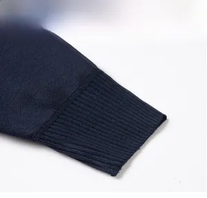 Macro detail shot showing the ribbed cuff and stitching of a navy blue men's hoodie