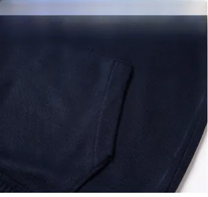 Close-up of neat hem stitching on a navy blue men's drawstring hoodie.