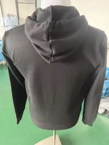 Detailed rear view of a black men's solid color hoodie showing the hood and ribbed hem