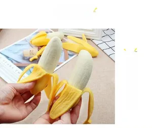 Detailed view of hand squeezing a peeling banana squishy toy for stress relief